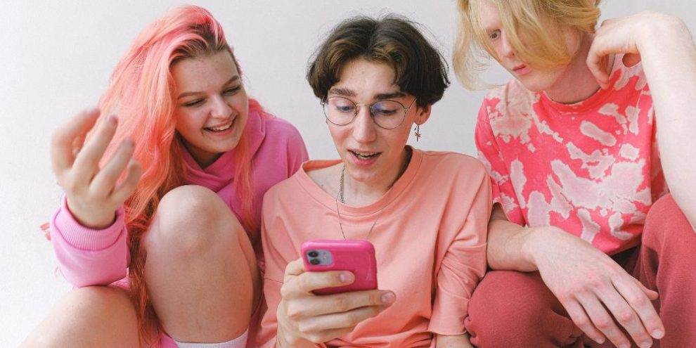 Women phone pink via pexels by Anna Shvets