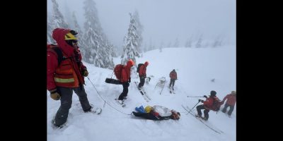 North Shore Rescue workers move a woman to safety along a trail near Pump Peak, in North Vancouver, B.C., in a Sunday, March 10, 2024, handout photo published to social media website Facebook. Rescuers say the woman is lucky to be alive after being caught in an avalanche on Metro Vancouver's North Shore and being completely buried upside down for up to 20 minutes. THE CANADIAN PRESS/HO-North Shore Rescue, *MANDATORY CREDIT* HO