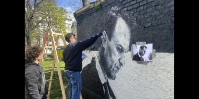 Austrian graffiti duo Joel Gamnou paint a picture of Alexei Navalny on a wall in Vienna, Austria, Wednesday, March 27, 2024. Two large portraits of the late Russian opposition leader Alexei Navalny have been spray-prainted on a property owned by the family of a former Czech foreign minister behind a monument to Soviet soldiers in Vienna. (AP Photo/Philipp-Moritz Jenne)