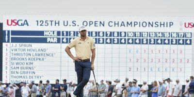 Sam Burns waits at the 18th green at Oakmont,