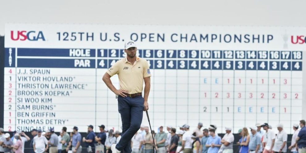Sam Burns waits at the 18th green at Oakmont,