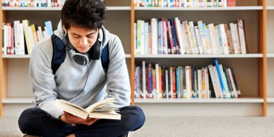 Boy reading at public library