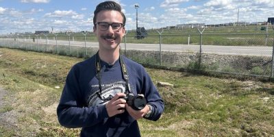 Man with camera near airstrip