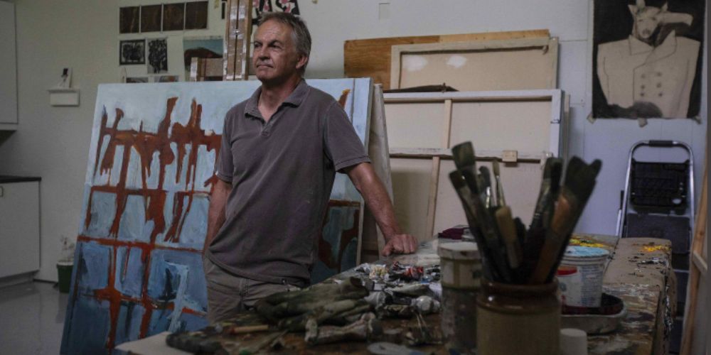 An artist reviewing a contract with a lawyer, symbolizing the importance of legal protection for creative rights