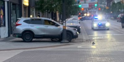 An SUV atop the sidewalk on the north side of Dunlop Street at Mary Street in dowtown Barrie
