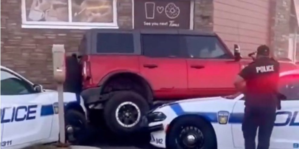 Man arrested after officers buck Bronco truck's attempt to drive over police cruisers