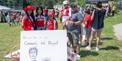 People pose for a photo during Barrie' Canada Day on the Move event in 2024
