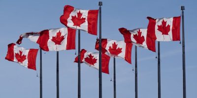 Canadian flags are seen flying behind the National Archives building in Ottawa