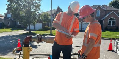 Two city works workers discussing a task.