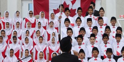 Children sing the Canadian national anthem at the Baitul Islam Mosque in Vaughan, Ont., during Canada Day festivities