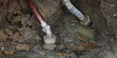 A copper water supply line, left, is shown connected to a water main after being installed for lead pipe, right, in Flint, Mich. - AP