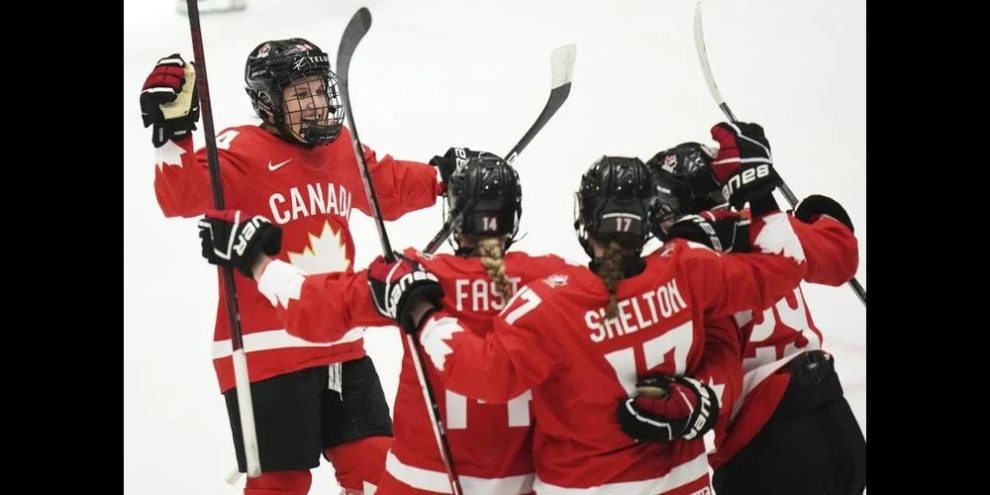 Canada's women's national ice hockey team celebrating a goal.