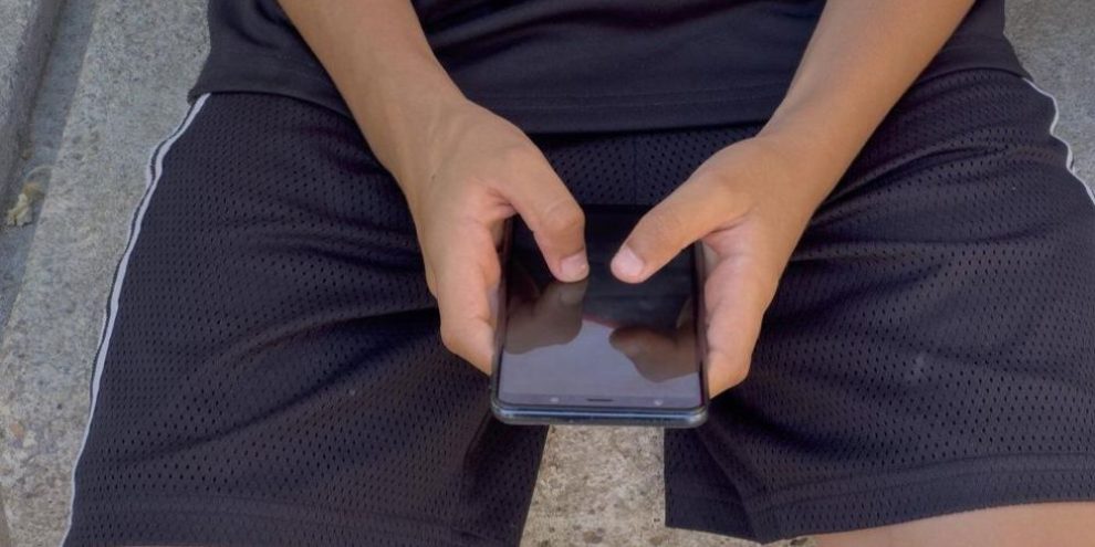 Child uses smartphone