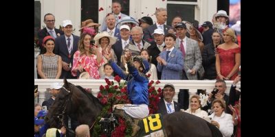 Junior Alvarado tossing rose petals in the air at Churchill Downs on the back of Sovereignty.