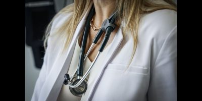A female doctor wearing a stethosocope.