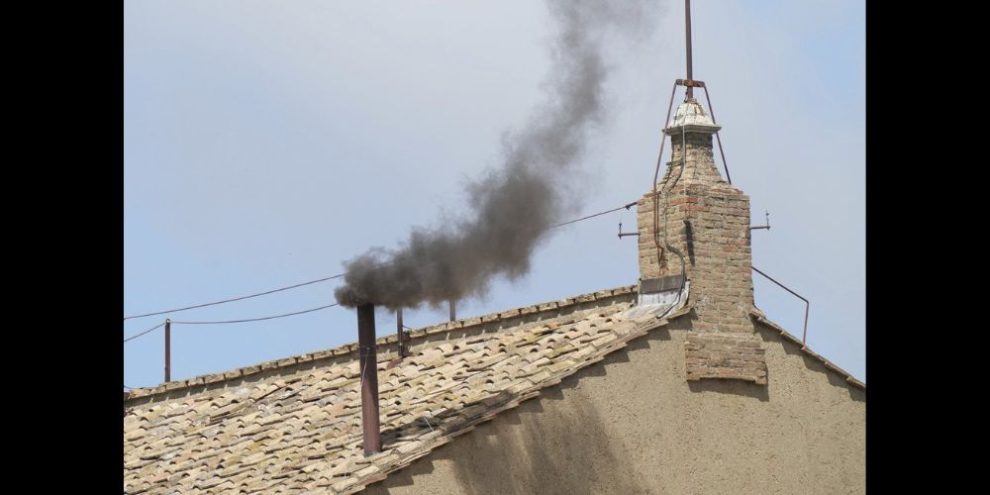 Black smoke billows from the chimney of the Sistine Chapel.