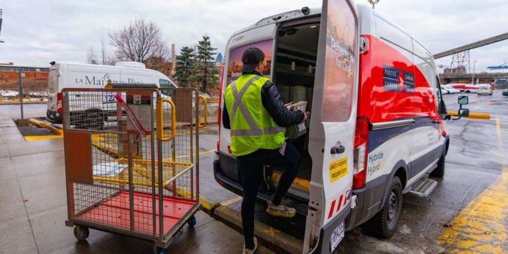 Postal worker stepping into van.