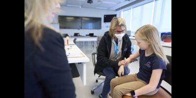 A young girl receives a vaccination shot.