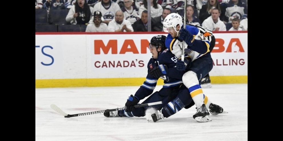 St. Louis Blues defenseman Cam Fowler checking WInnipeg Jets forward Mark Scheifele