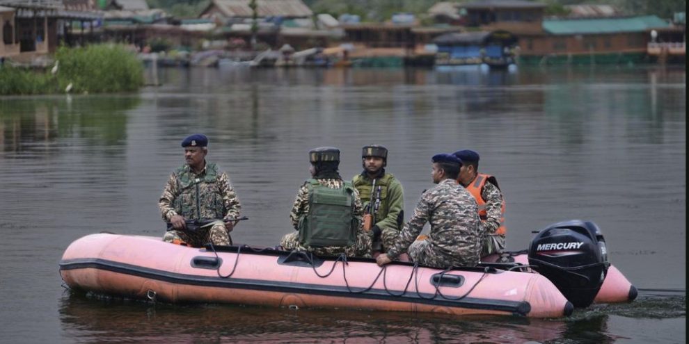 Military crew on a river craft.