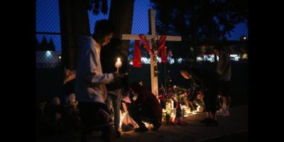 Families mourning at a candle-lit vigil