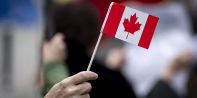 Hand waving mini Canadian flag