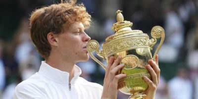 Jannik Sinner of Italy holds the trophy after winning the men's singles final match against Carlos Alcaraz of Spain at the Wimbledon Tennis Championships in London