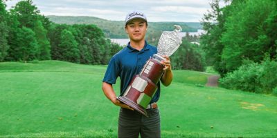 Eric Zhao holds the trophy as Ontario's amateur golf champion