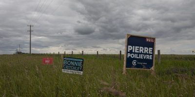 A campaign sign for Independent candidate Bonnie Critchley stands next to signs for Pierre Poilievre and Darcy Spady in the riding of Battle River-Crowfoot in Camrose, Alta