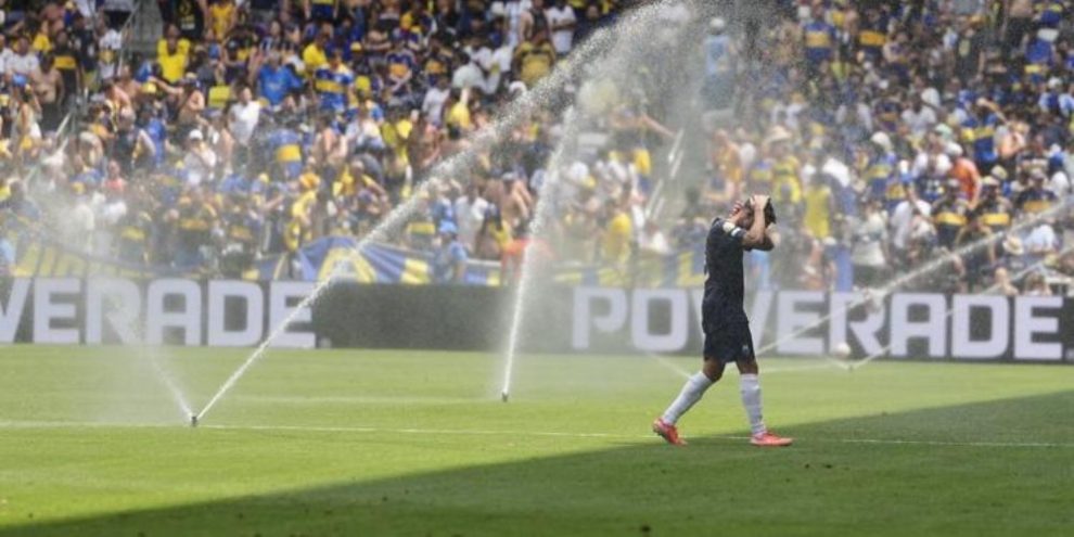 Auckland City's Gerard Garriga cools off under the sprinklers during a water break in the Club World Cup Group C soccer match between Auckland City and Boca Juniors in Nashville, Tenn.