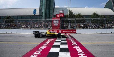 Colton Herta (26) of the United States crosses the finish line to win the 2024 Ontario Honda Dealers Indy in Toronto
