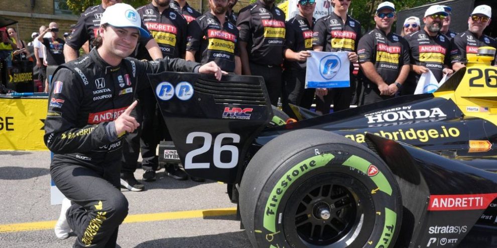 With members of his team behind him, Colton Herta of the United States celebrates taking the pole position for the 2025 Honda Indy Toronto