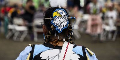 A dancer wears beaded regalia as they prepare to compete in the Summer Solstice Indigenous Festival's 2024 Competition Pow Wow at Madahoki Farm in Ottawa