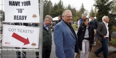 Doug Ford leaves the Muskoka Craft Beer Festival in Huntsville, smiling amid a crowd of festivalgoers.