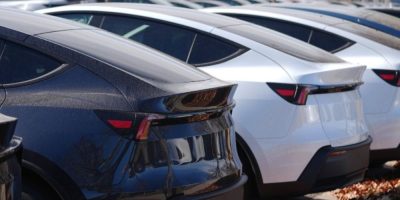 Unsold 2026 Tesla Model Y vehicles parked in a holding lot in northeast Denver.