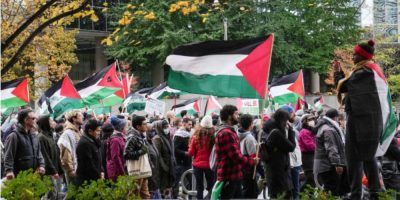 A pro-Palestinian march moves through Toronto on Oct. 29, 2023, with participants walking along city streets.