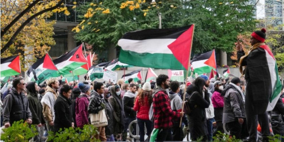 A pro-Palestinian march moves through Toronto on Oct. 29, 2023, with participants walking along city streets.