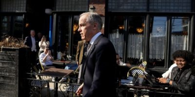 Prime Minister Mark Carney walking through a Toronto neighbourhood on March 30, 2026, during a visit to a local business ahead of unveiling Canada’s nature conservation strategy.
