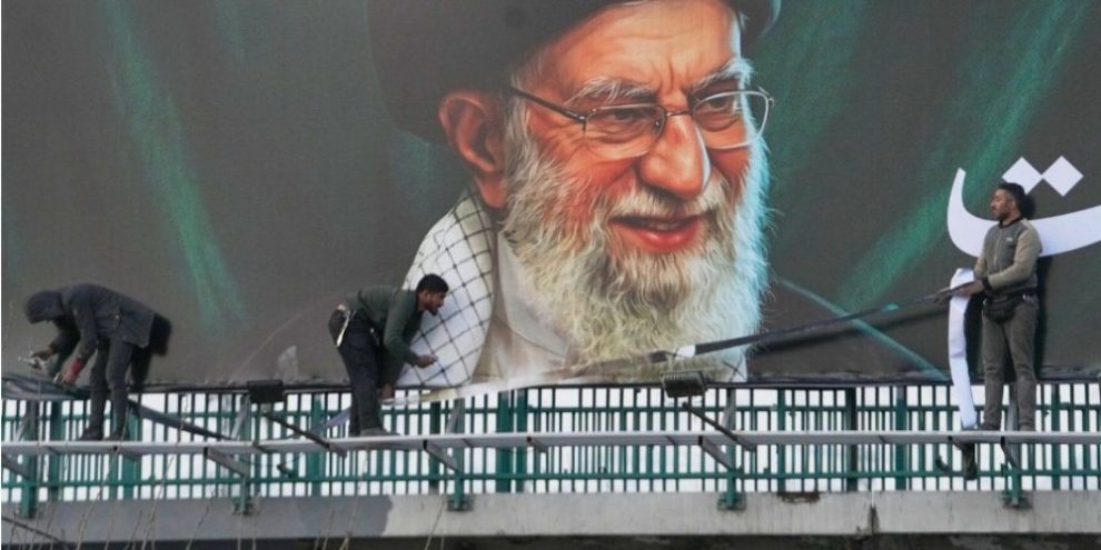 Workers install a billboard in Tehran showing a portrait of Iran’s late Supreme Leader Ayatollah Ali Khamenei following joint U.S.-Israeli military attacks, March 2, 2026.