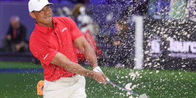 Tiger Woods plays a shot from a bunker at the TGL golf tournament in Palm Beach Gardens, Florida, March 24, 2026.