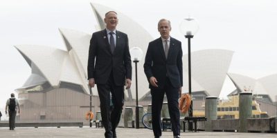 Prime Minister Mark Carney and Defence Minister David McGuinty walk to a news conference in Sydney, Australia, on March 4, 2026.