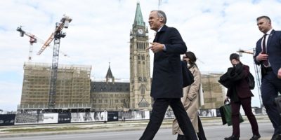 Mark Carney walking toward West Block on Parliament Hill