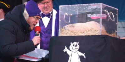 Mayor Jay Kirkland and former MPP Bill Walker checking Wiarton Willie during Groundhog Day celebrations in Wiarton, Ontario
