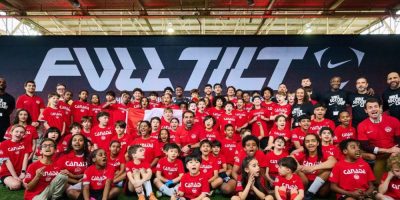 Young soccer players pose for a group photo during the unveiling of Canada’s 2026 World Cup jerseys at an event in Toronto on March 16, 2026.
