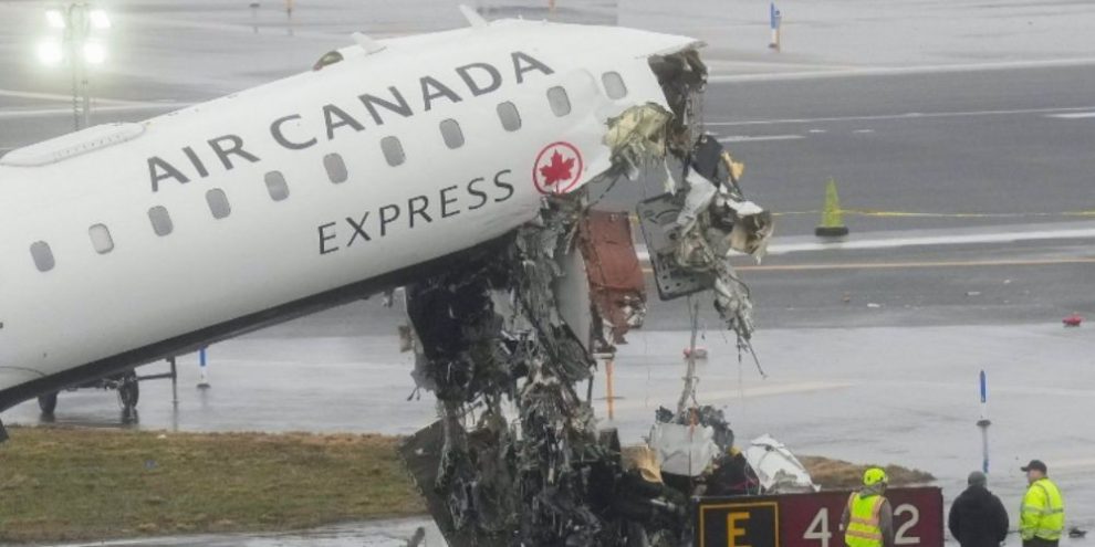 Officials examine the crash site at LaGuardia Airport on March 23, 2026, where an Air Canada jet collided with a Port Authority fire truck.