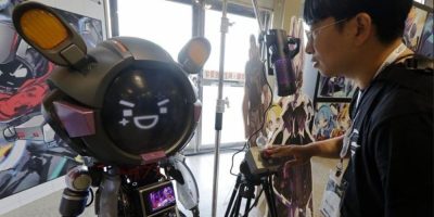 A man communicates with an ASUS ROG Omni AI assistant during the AI EXPO in Taipei, Taiwan, on March 25, 2026.