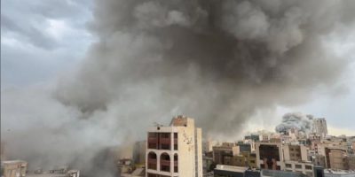 Plumes of smoke rise over Tehran, Iran, from two simultaneous strikes, showing the intensity of the Middle East conflict.