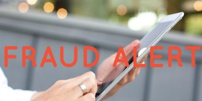 Fraud alert graphic displayed over a person holding a cellphone, representing cryptocurrency scams targeting online users.