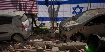 Israeli and U.S. flags hung at a site in Ramat Gan struck by an Iranian missile, which killed two people on March 18, 2026.