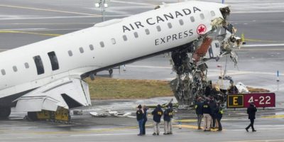 National Transportation Safety Board officials examine the Air Canada jet collision site at LaGuardia Airport on March 23, 2026.
